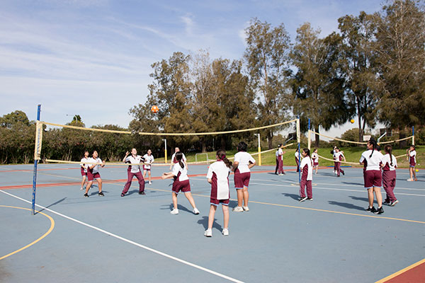 Students at Mary MacKillop Catholic College Wakeley playing game on volleyball court