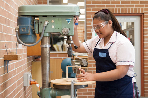 Mary MacKillop Catholic College Wakeley student woodworking inside school workshop